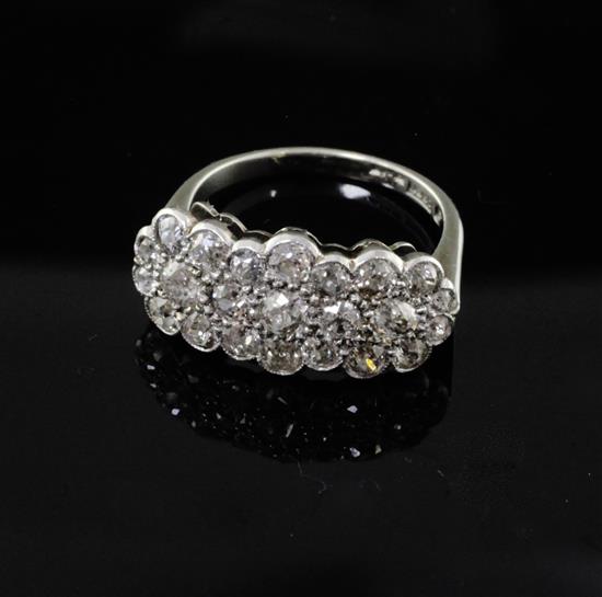 An 18ct gold, platinum and diamond set triple flower head cluster ring, size M.